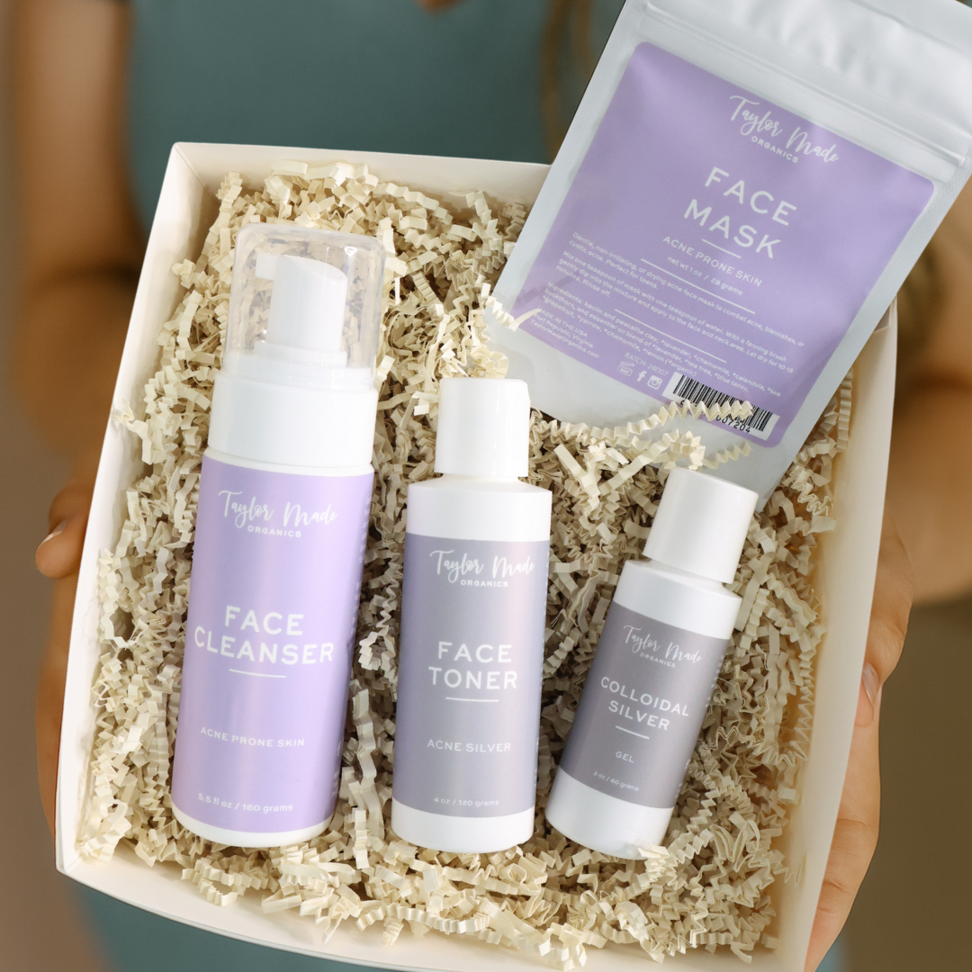 Set of facial skincare products including cleanser, toner, and mask in a box.