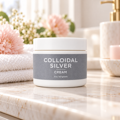 Taylor Made Organics Colloidal Silver Cream made with 150pm sitting on a bathroom counter with a towel and fresh flowers. Made in the USA