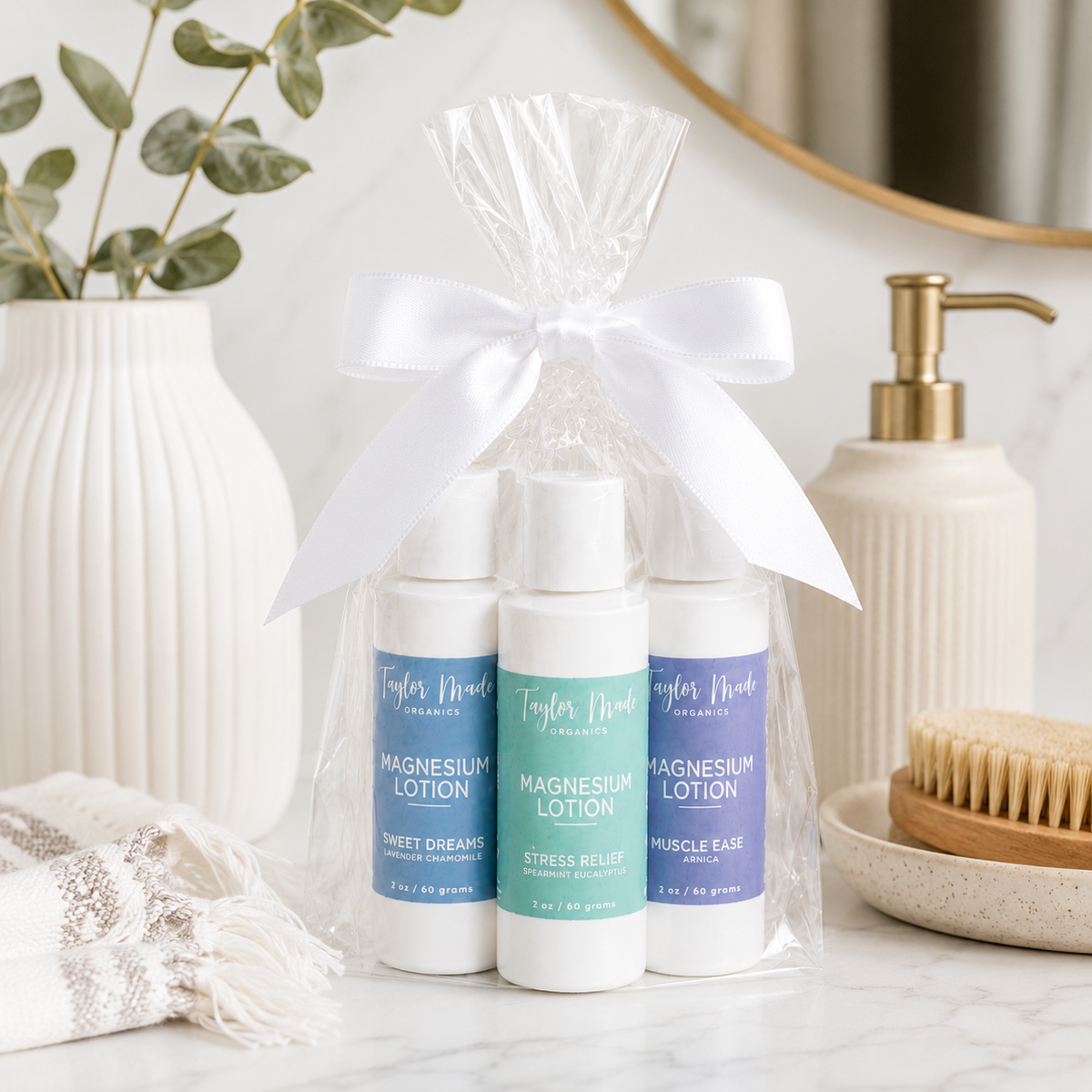 Taylor Made Organics Comfort Gift Set with travel-size Sweet Dreams, Stress Relief, and Muscle Ease Magnesium Lotions in a bow-tied gift bag.
