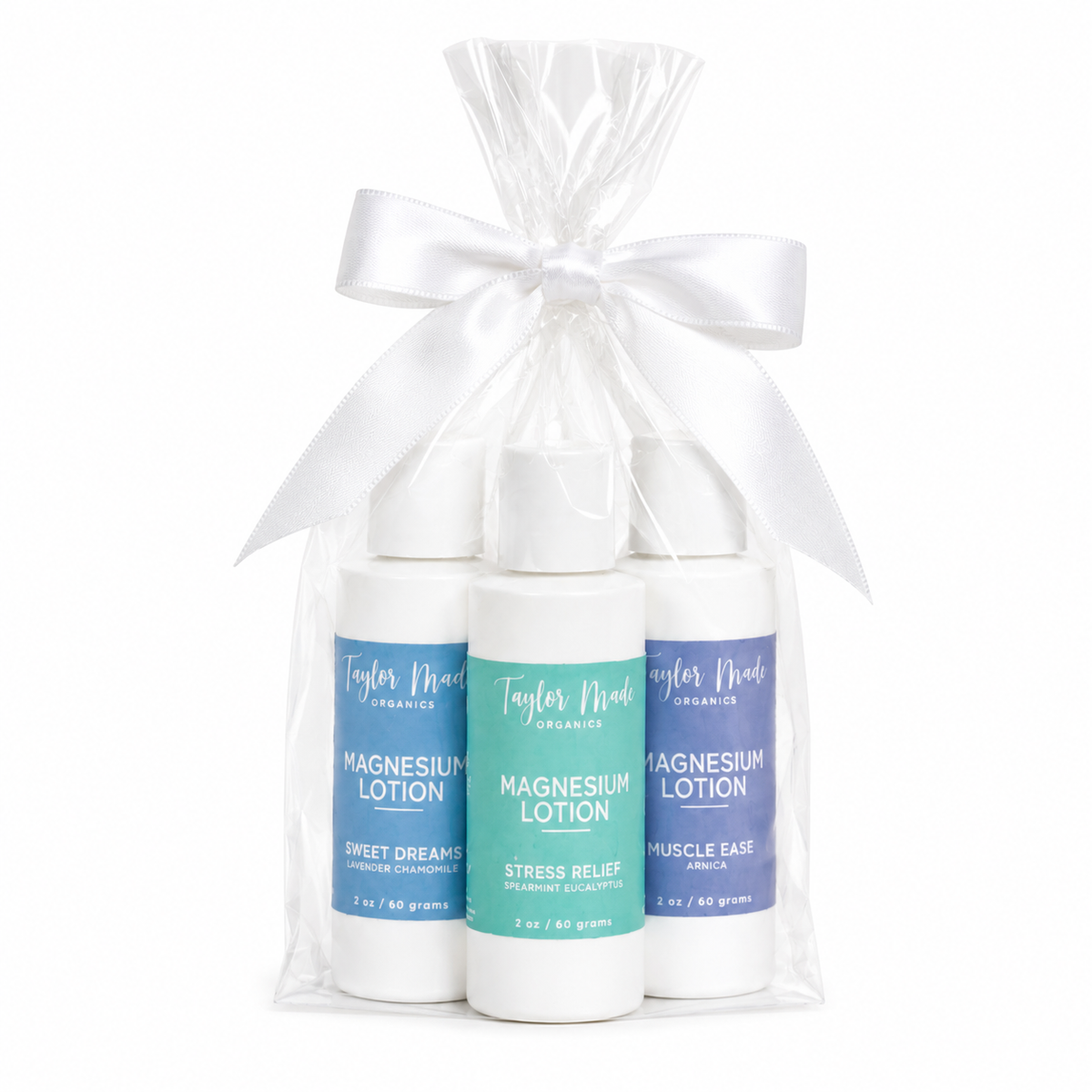Taylor Made Organics Comfort Gift Set with three travel-size magnesium lotions in a clear gift bag with a white bow.