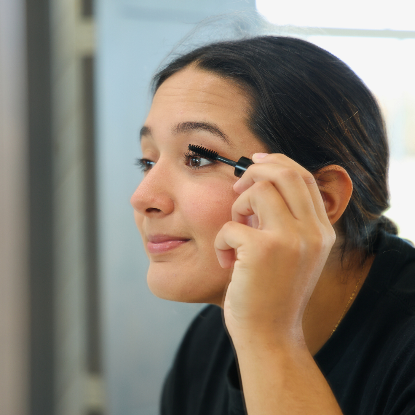 Model Applying Mascara | Taylor Made Organics