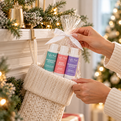 A woman placing the Mindful Moments Lotion Gift Set into a Christmas Stocking. 