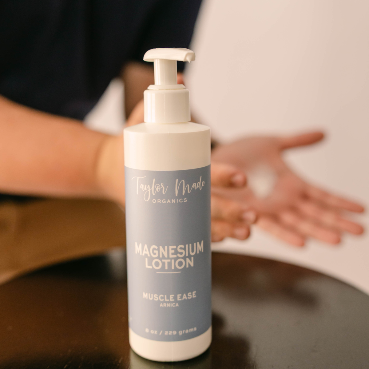 Taylor Made Organics Muscle Ease Magnesium Lotion with arnica in an 8-ounce pump bottle.